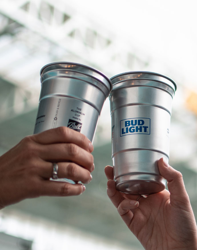 Two Ball Aluminum Cups held in a cheers motion