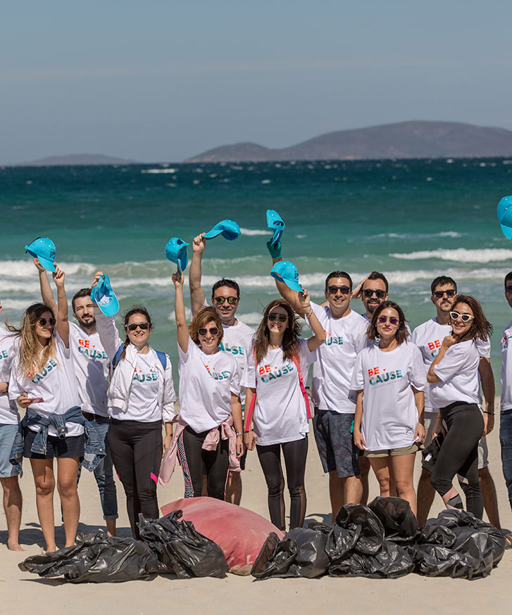 Volunteers standing together on a beach