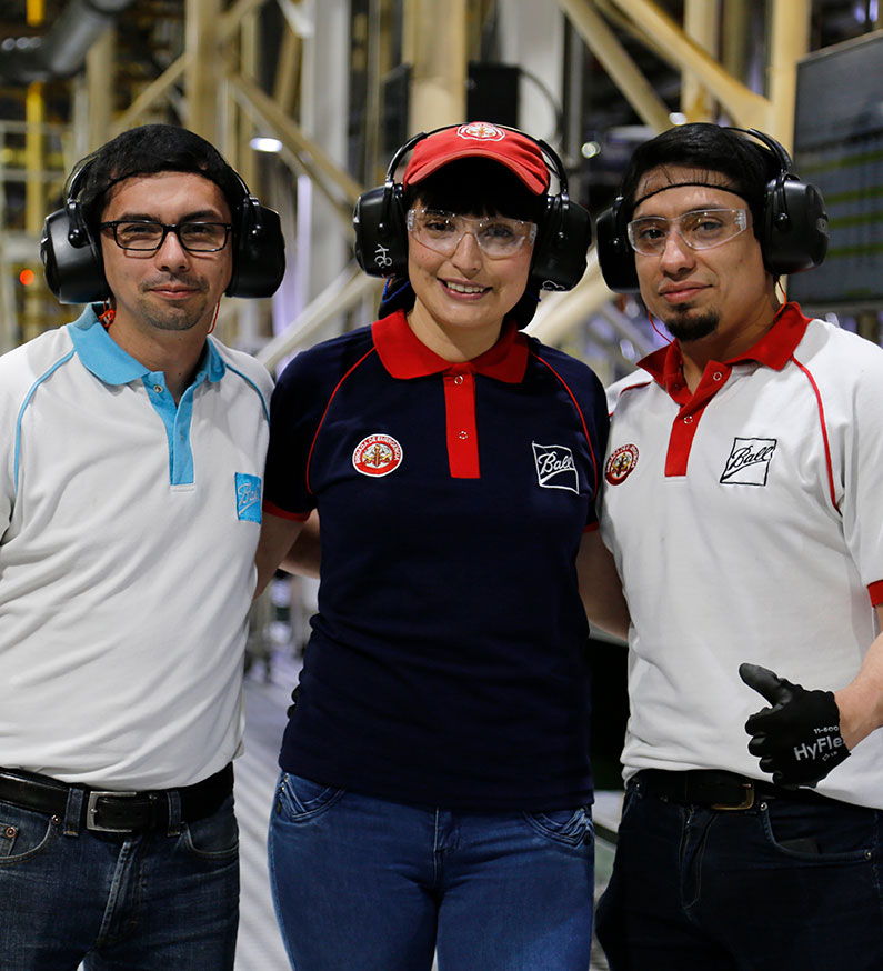 Smiling factory workers standing together