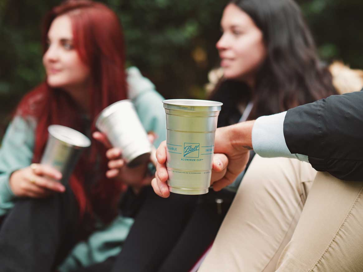 People outside holding Ball Aluminum Cups