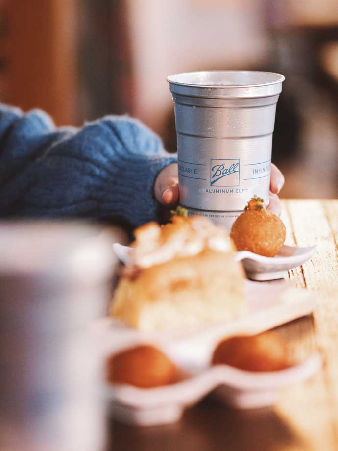 One Ball Aluminum cup at a table with food